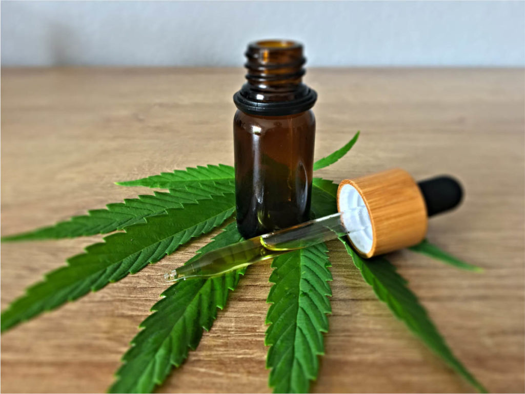 CBD oil on top of a cannabis leaf